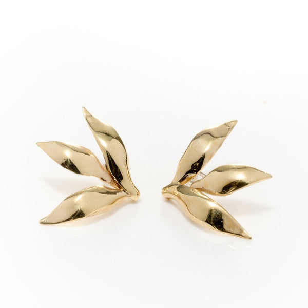 Gold leaf-shaped earrings on a white background