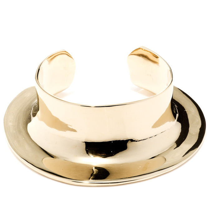 Gold cuff bracelet on a white background